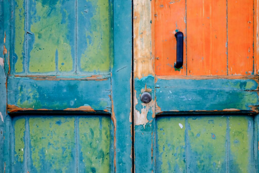 closeup view of blue and green wooden door